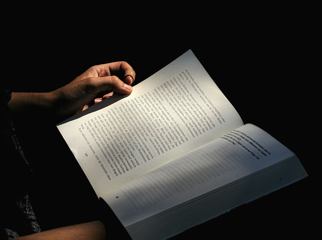 Close-up of hands reading a printed investigative report