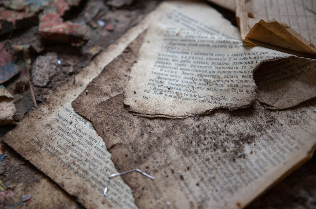 Stack of old newspapers and documents on a wooden table