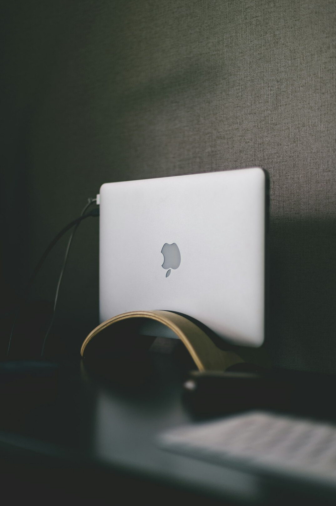 Desk with a laptop, notebook and coffee cup from above